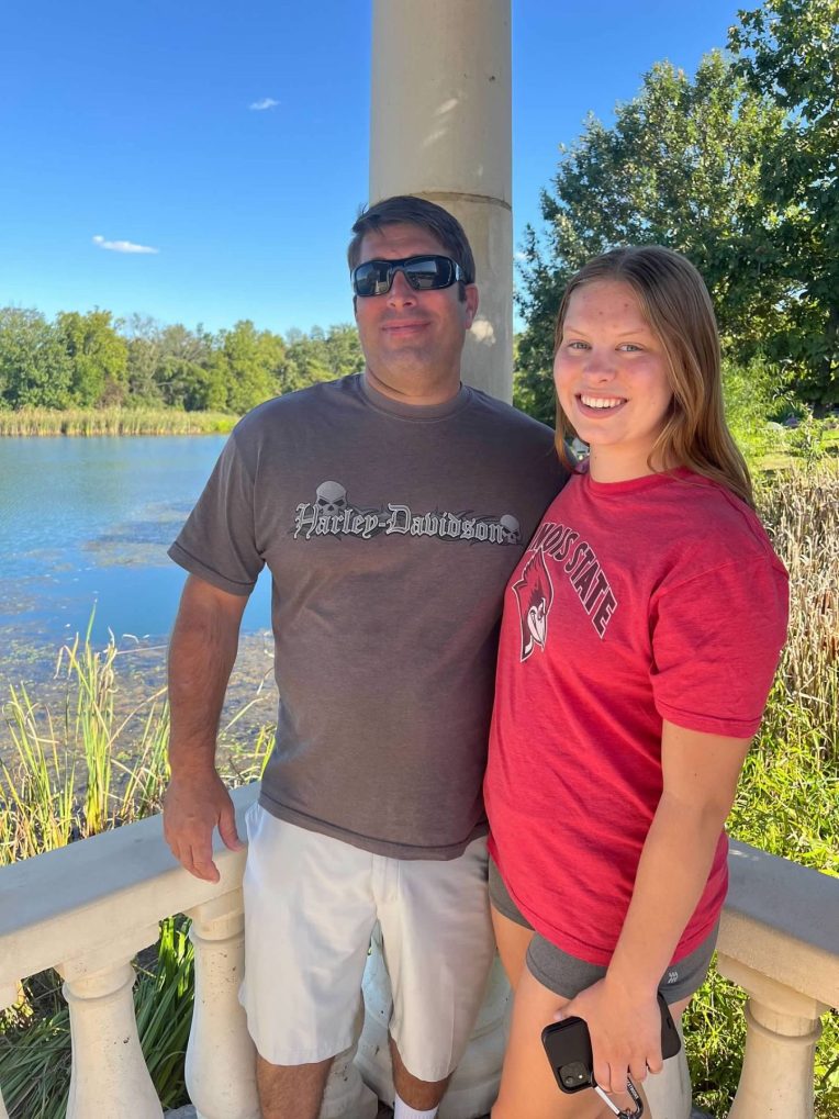 Katelyn and her father pose outdoors